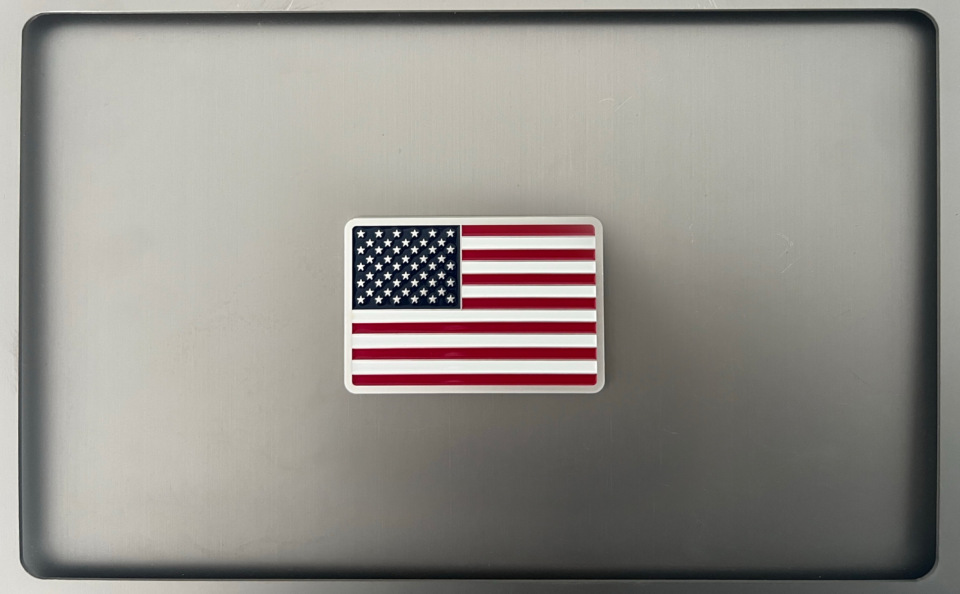 Rectangular American flag magnet displayed on a metal surface